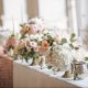 Top wedding table with bridesmaids bouquet in vases with rose gold runner