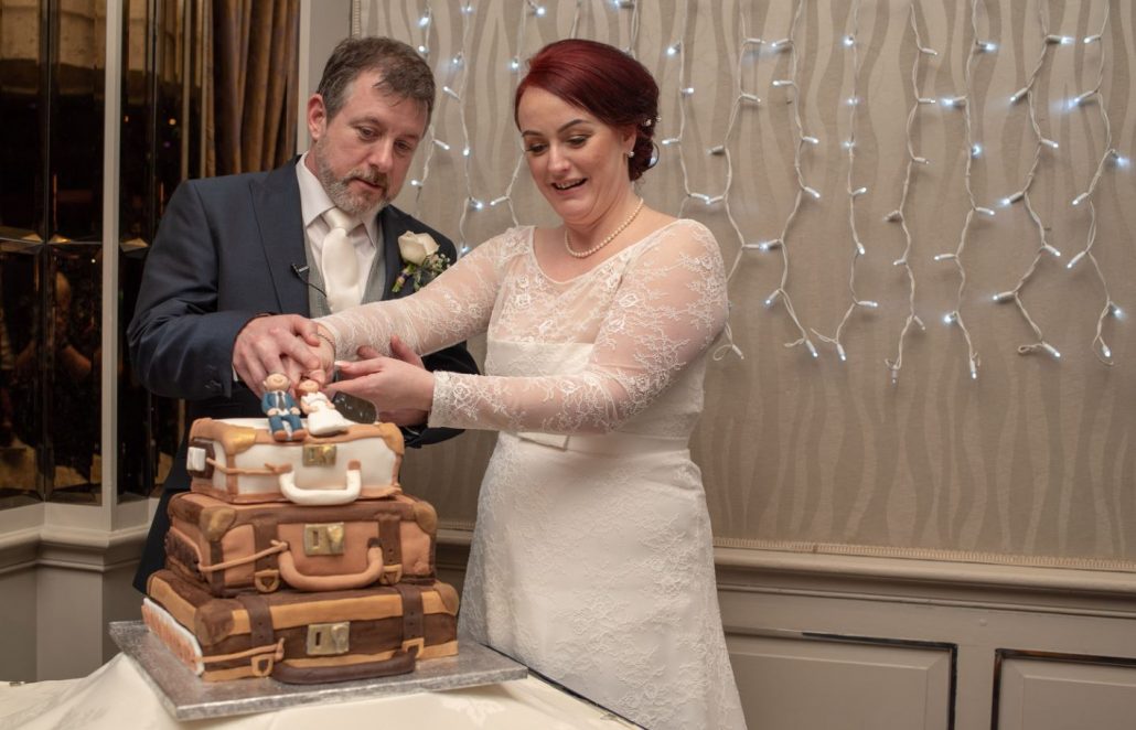 Bride and groom cutting their cake