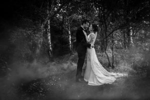 Bride and groom by the lake at Alderford